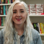 Holly Jackson in front of a bookcase